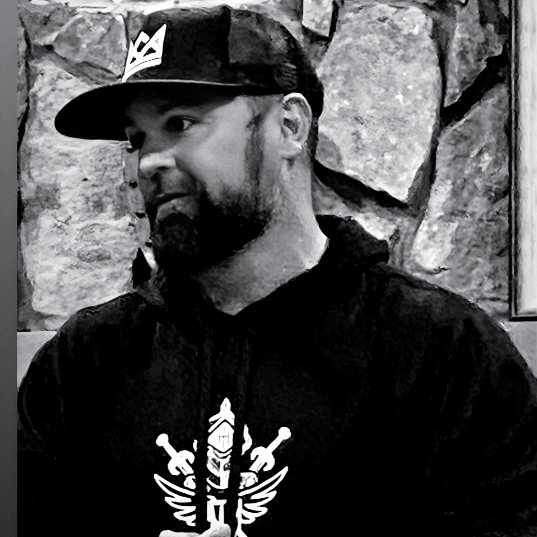 A black and white portrait of Vision Warriors founder Kirk Driskell wearing a Vision Warriors hoodie, representing the heart of the North Atlanta recovery non-profit.